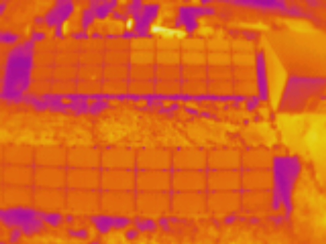 Aerial thermal image of multiple rooftop solar arrays